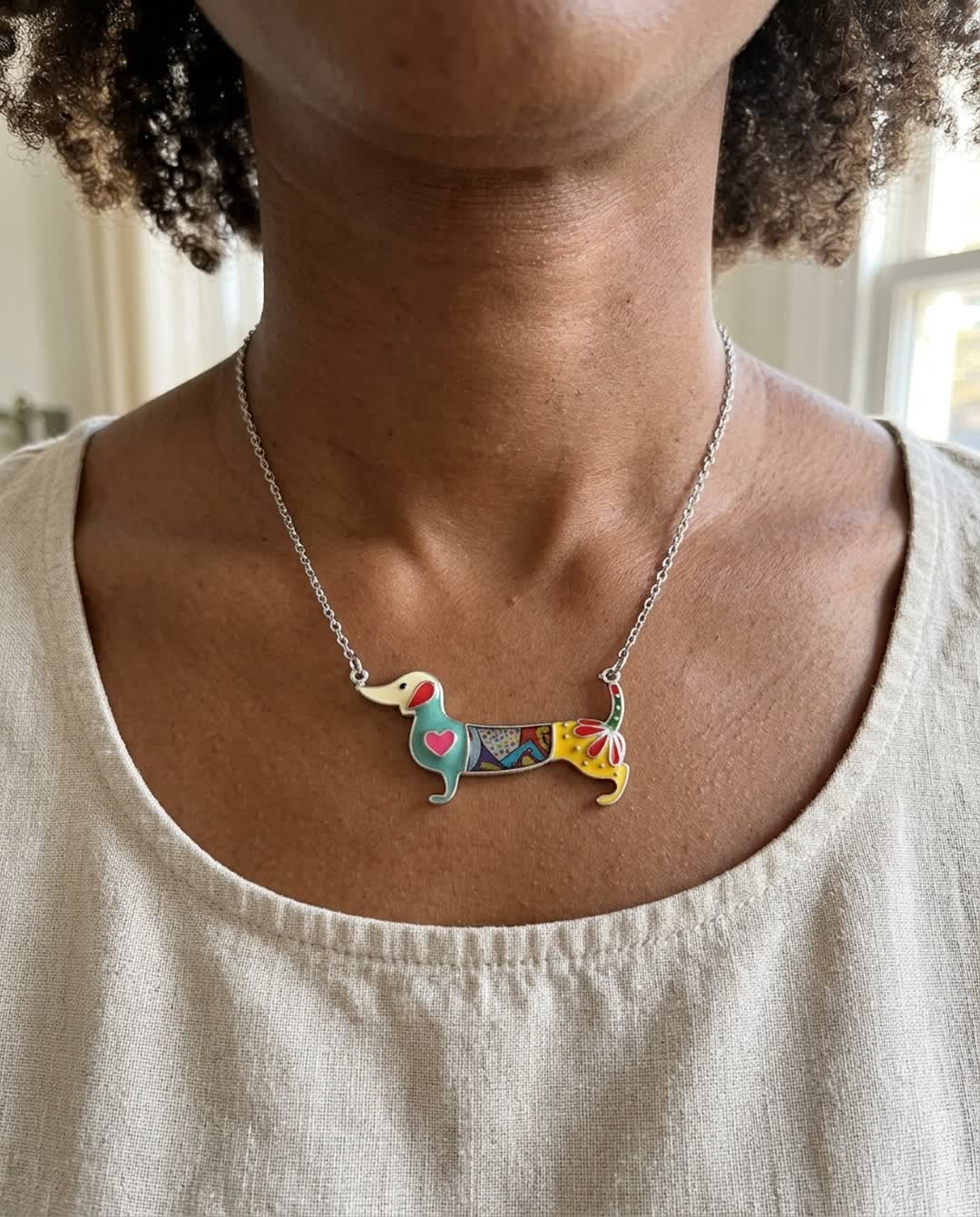 Close-up of the enameled color dachshund pendant on its chain