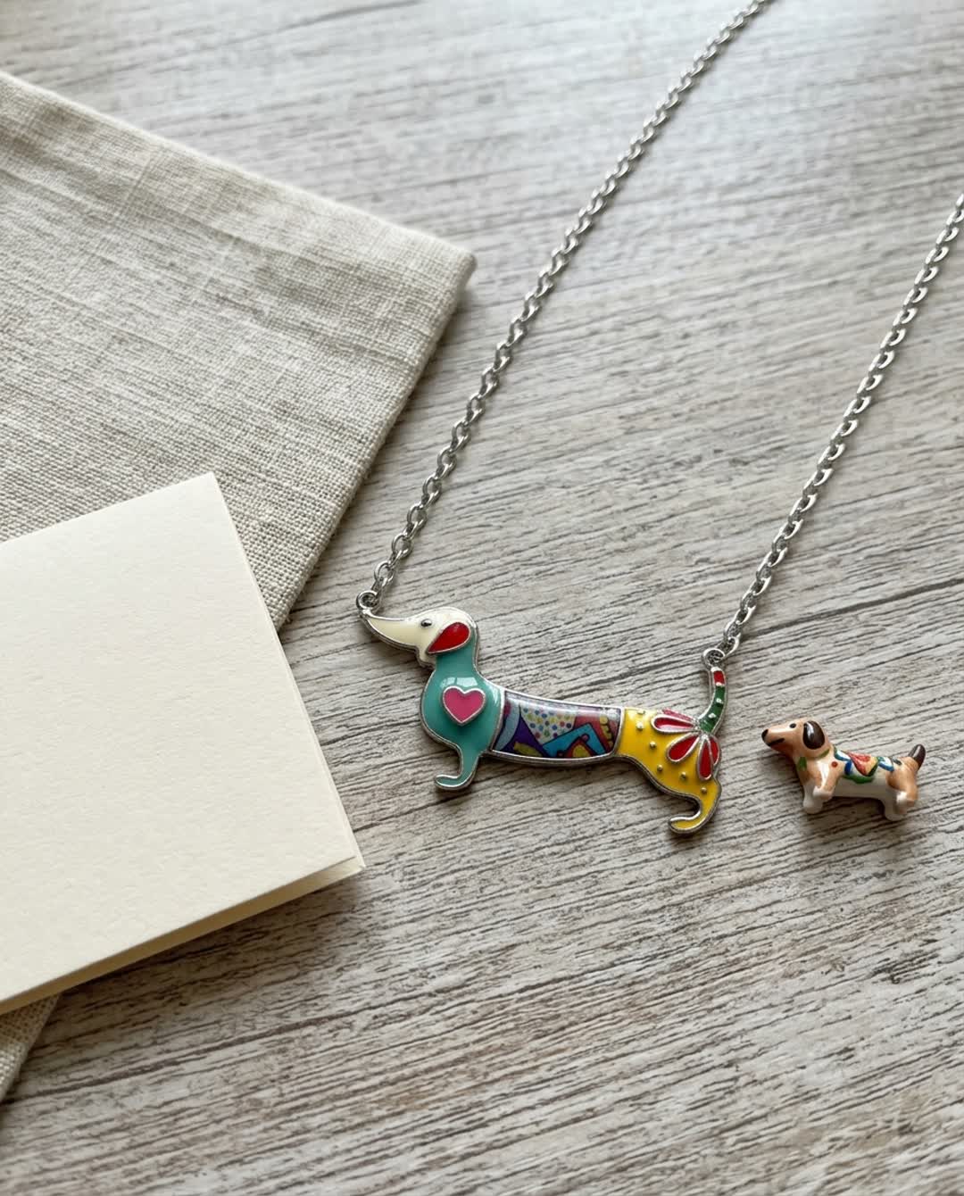 The Rescue Necklace laid flat with its chain